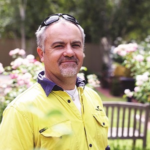 Gardener Joe smiles at the camera