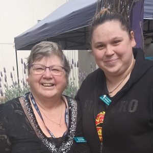 Heather and Tiffany, volunteers at Lightsview, smile at the camera