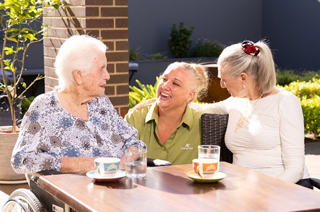 Three women talking at table