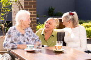 Three women talking at table