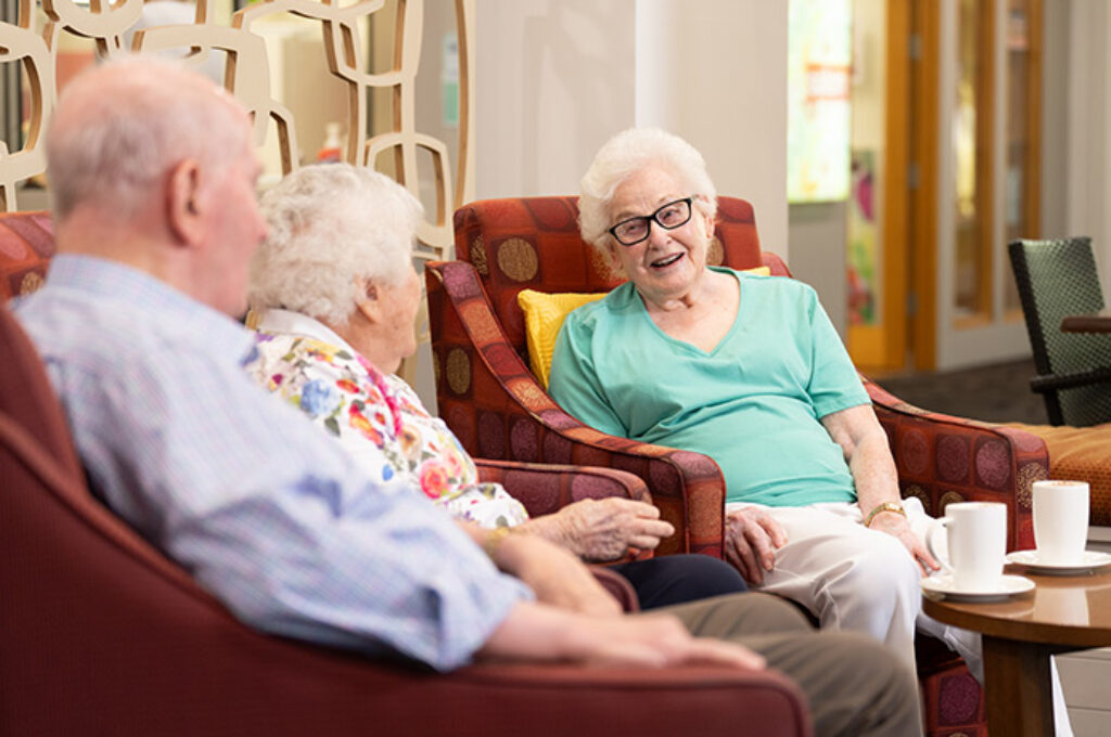 Group of elderly people chatting on armchairs