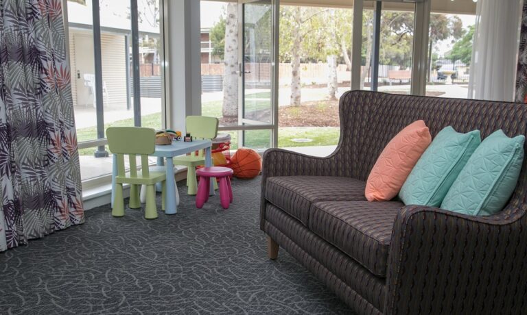 Group of three in lounge chairs having a chat