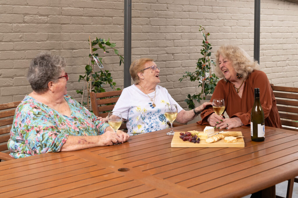 Group of three women having a platter and chatting