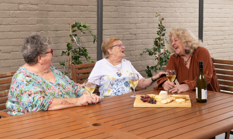 Group of three women having a platter and chatting