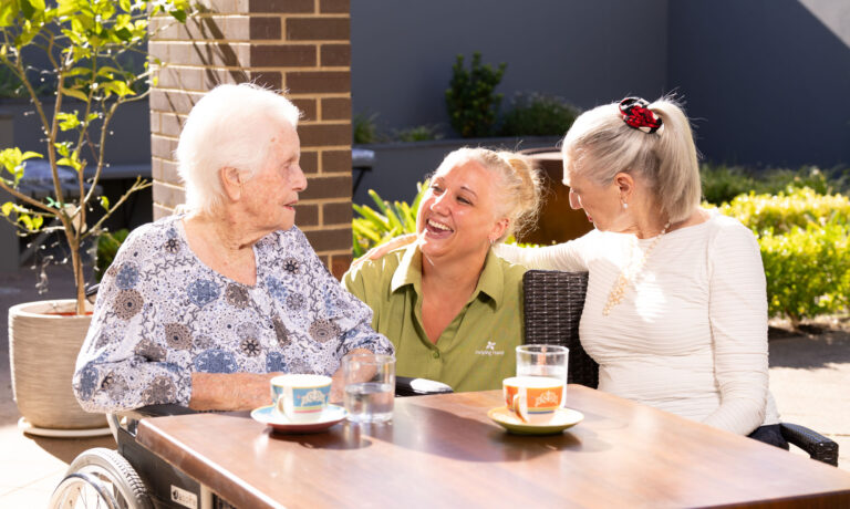 Helping Hand worker socialising with two residents